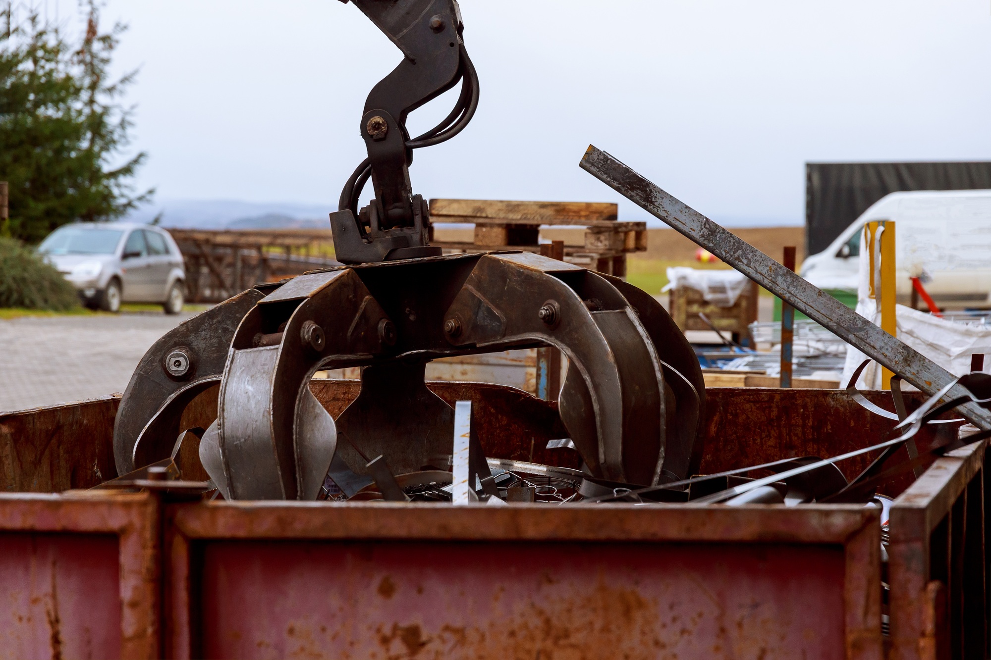 Loading scrap metal into a truck. Crane grabber loading metal rusty scrap in the dock